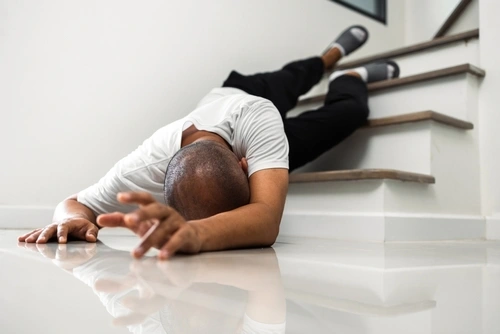 man who needs a North Carolina slip and fall lawyer after falling down stairs