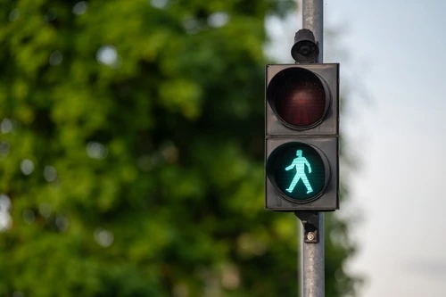 A traffic light with a green pedestrian signal represents pedestrian rights in North Carolina.