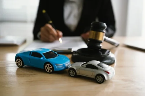 Wilmington drunk driving accident lawyer at desk with toy cars