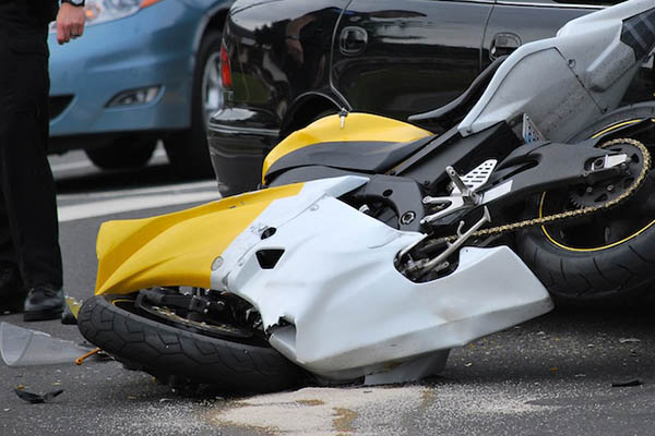 Motorcycle on its side after a North Carolina motorcycle accident where insurer bias affects the injured rider's claim and a motorcycle accident lawyer is needed