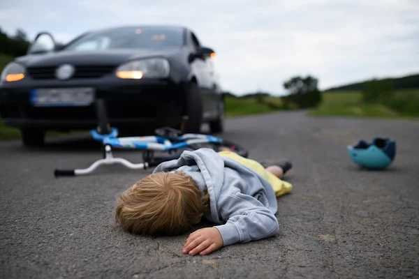 A little boy has been knocked off his bicycle and needs a bike accident lawyer.